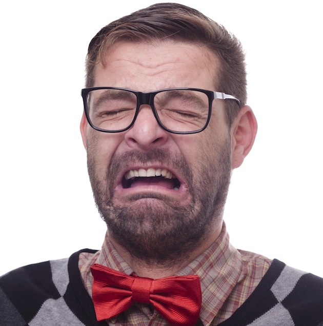 Portrait of a crying nerd. Isolated on white.
